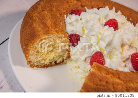 Pastry, Traditional Italian rum cake with whipped cream and raspberries 86011509