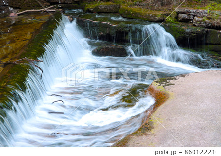 Beautiful little waterfall of the river in the forest. 86012221