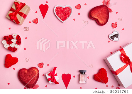 Valentine's Day. Frame made of hearts, gifts, candles, confetti on pink background. Valentines day background. Valentine's Day. Frame made of hearts, gifts, candles, confetti on pink background. Valentines day background. 86012762