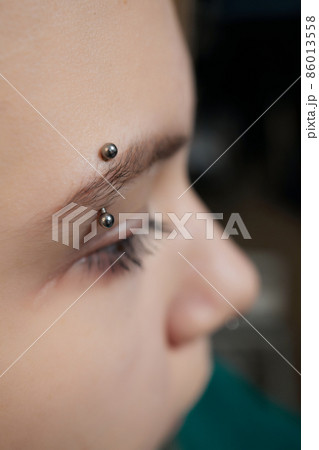 smile or frenulum piercing under the upper lip. smile or frenulum piercing under the upper lip. 86013558