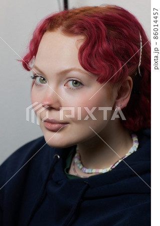 A beautician makes a puncture of the earlobe with a disposable device in a beauty salon. Ear piercing lobe. A beautician makes a puncture of the earlobe with a disposable device in a beauty salon. Ear piercing lobe. 86014457