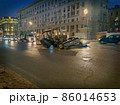 Broken agricultural tractor on night Moscow street, Russia 86014653