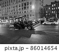 Broken agricultural tractor on night Moscow street, Russia 86014654