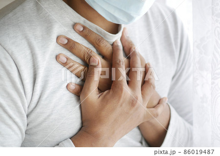 young sick man coughing and sneezes  86019487