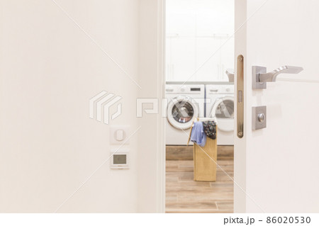 View through door to laundry room with basket and washing machine View through door to laundry room with basket and washing machine 86020530