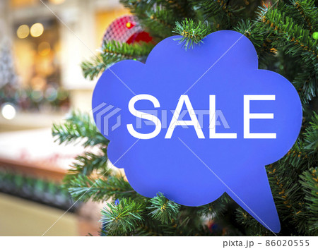 Sign on a xmas tree in shopping mall 86020555