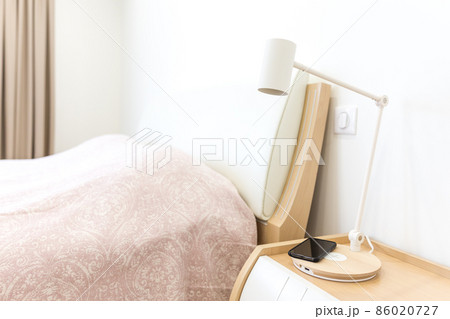 Wireless smartphone charging on lamp near bed 86020727