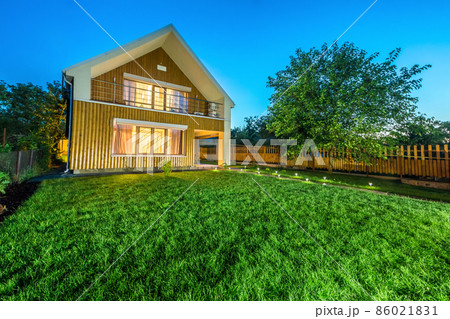 Wooden house with meadow in front of it Wooden house with meadow in front of it 86021831