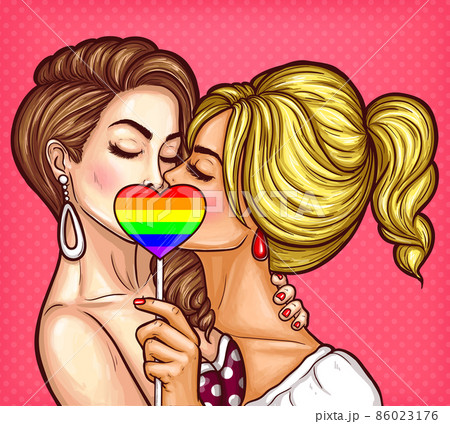 Vector pop art lesbian couple kissing and covering their lips with sign on stick in the form of a rainbow heart 86023176