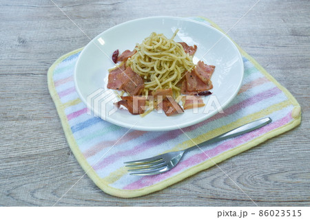 fried spaghetti topping crispy bacon and slice dry chili on plate fried spaghetti topping crispy bacon and slice dry chili on plate 86023515