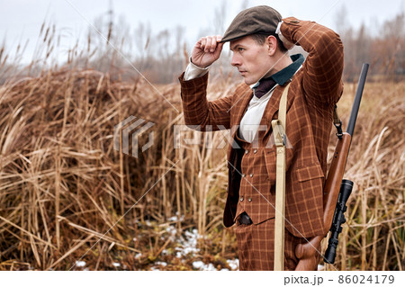 Young caucasian hunter. American hunting rifles. Hunting without borders, with shotgun Young caucasian hunter. American hunting rifles. Hunting without borders, with shotgun 86024179