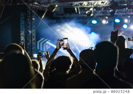 silhouettes of crowd at concert near stage silhouettes of crowd at concert near stage 86025248