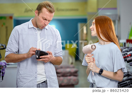 Adult Redhead Female Ask Husband To By Hair Dryer, Begging. Man Has No Money Adult Redhead Female Ask Husband To By Hair Dryer, Begging. Man Has No Money 86025420