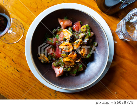 Mediterranean cuisine - mussels and tomatoes with arugula pesto closeup 86029779