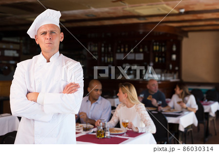Portrait of pensive chef with crossed arms in restaurant 86030314