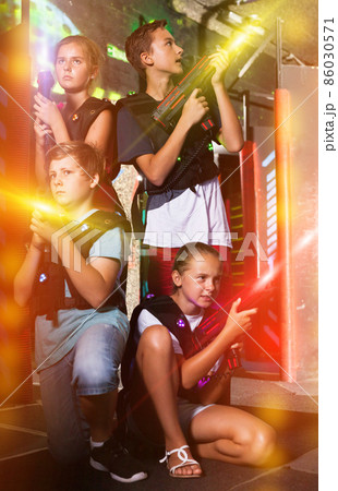 Happy teenagers with laser guns Happy teenagers with laser guns 86030571