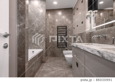 Modern minimalist bathroom beige interior design with marble tiles and glossy beige furniture Modern minimalist bathroom beige interior design with marble tiles and glossy beige furniture 86030991