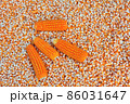 Close up  dried yellow corn kernels are lined up in the background. 86031647