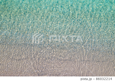 Background, texture of relaxing, calm turquoise, transparent sea water with stones. Summer vacation. Blue ocean lagoon. Drone, copter top view. Background, texture of relaxing, calm turquoise, transparent sea water with stones. Summer vacation. Blue ocean lagoon. Drone, copter top view. 86032214