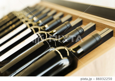 Wine bottles with blank labels on the counter of a liquor store. Wine background. Selected focus Wine bottles with blank labels on the counter of a liquor store. Wine background. Selected focus 86032250