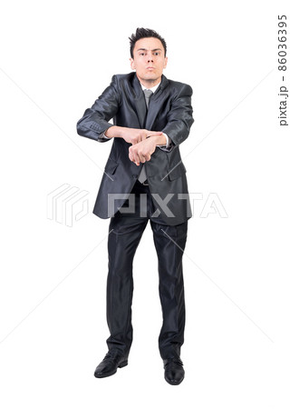 Businessman showing being late gesture in studio 86036395