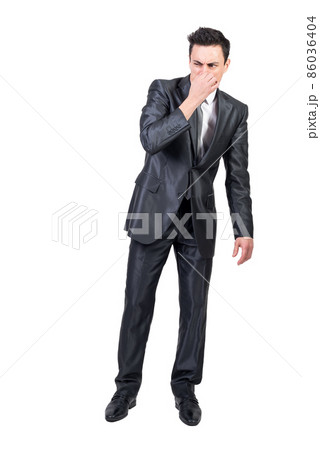 Businessman feeling bad smell in studio. White background. Businessman feeling bad smell in studio. White background. 86036404