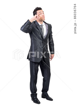 Smart businessman touching temple in studio. White background. Smart businessman touching temple in studio. White background. 86036764