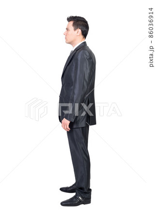 Serious male manager in suit standing in white studio Serious male manager in suit standing in white studio 86036914