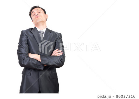 Self assured businessman with folded arms looking at camera Self assured businessman with folded arms looking at camera 86037316