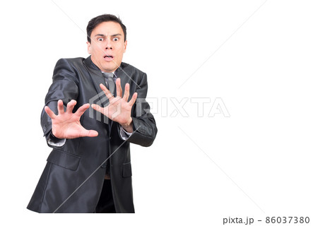Shocked businessman gesturing and looking at camera with scared face Shocked businessman gesturing and looking at camera with scared face 86037380