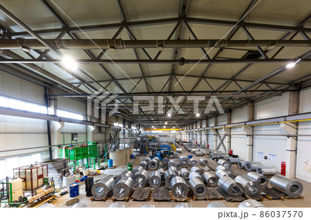 Photo of production line of metal tile for roof. Steel forming machine in metalwork factory workshop 86037570