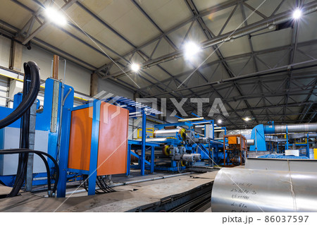 Production line of metal tile for roof. Steel forming machine in metalwork factory workshop. Metal Production line of metal tile for roof. Steel forming machine in metalwork factory workshop. Metal 86037597
