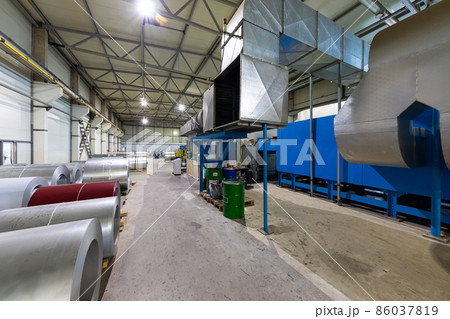 Photo of steel roofing forming machine. Industrial machine for metal sheet roof coils cut. Factory Photo of steel roofing forming machine. Industrial machine for metal sheet roof coils cut. Factory 86037819