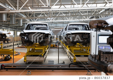 Photo of automobile production line. Modern car assembly plant. Auto industry. Interior of a high 86037837
