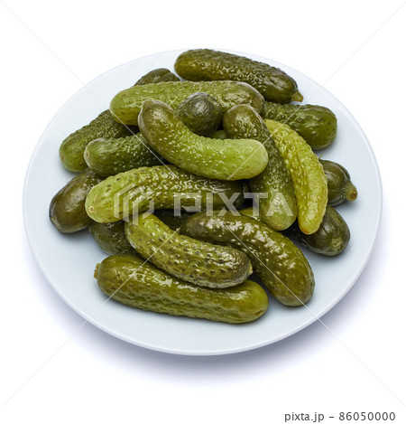 Plate of Tasty canned Whole green cornichons isolated on a white background 86050000