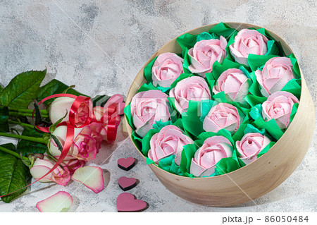 Handmade marshmallows in wooden packages on a light background with flowers. The concept of the holidays Women's Day and Valentine's Day. Handmade marshmallows in wooden packages on a light background with flowers. The concept of the holidays Women's Day and Valentine's Day. 86050484