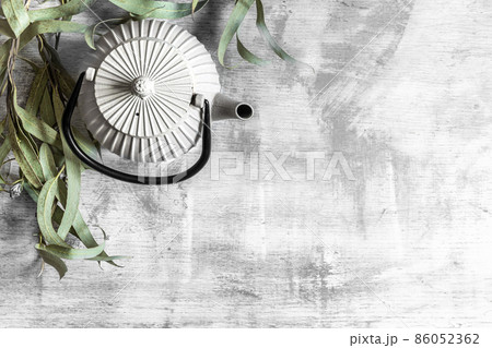 Beautiful ceramic teapot on a concrete background, top view, copy space. 86052362