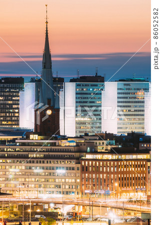 Stockholm, Sweden. Close View Of St. Clara Or Saint Klara Church And Houses In Twilight Dusk Lights. Evening Night Lighting Stockholm, Sweden. Close View Of St. Clara Or Saint Klara Church And Houses In Twilight Dusk Lights. Evening Night Lighting 86052582