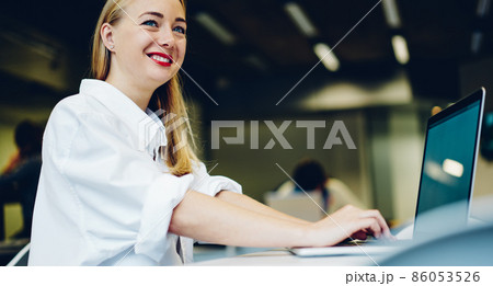Happy female with laptop in office Happy female with laptop in office 86053526