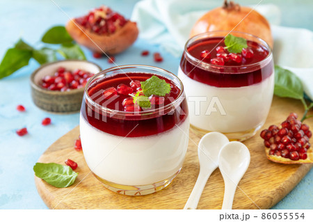 Winter panna cotta with pomegranate jelly and mint, italian dessert, homemade cuisine. 86055554