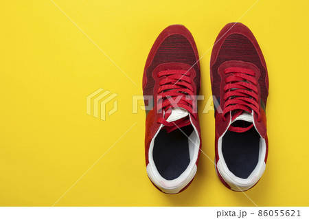 New unbranded running sneaker or trainer on yellow background. Men's sport footwear. 86055621