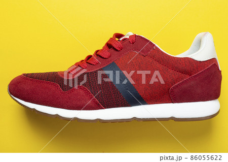 New unbranded running sneaker or trainer on yellow background. Men's sport footwear. New unbranded running sneaker or trainer on yellow background. Men's sport footwear. 86055622