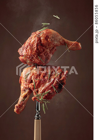 Chicken drumsticks on a fork. Chicken drumsticks on a fork. 86055856