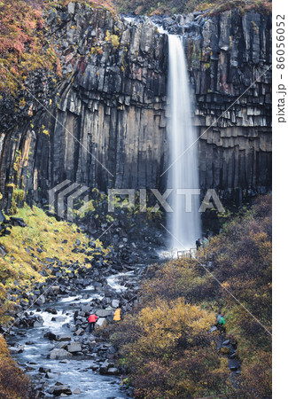 Svartifoss waterfall silk water in Skaftafell national park in Iceland with tourists 86056052