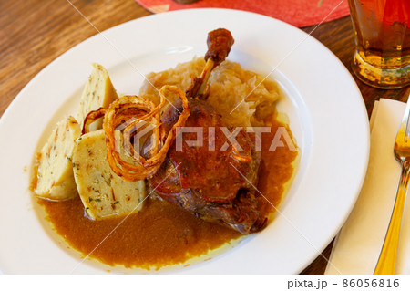Confit duck leg with sauerkraut and dumplings 86056816