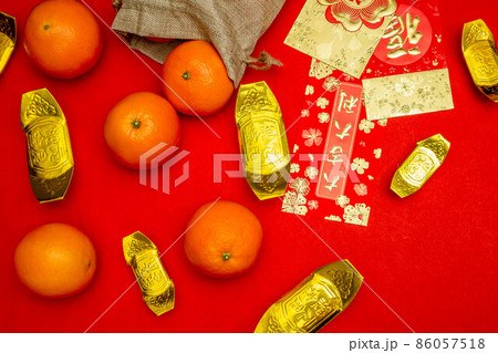 Flat lay mockup for holiday Chinese new year red packet and gold accessories blossom and Lunar festival background, means wealthy or rich and happiness. 86057518
