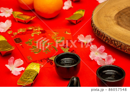Above view accessories of Chinese new year or Mood day festival oranges gold and Angpao pockets whit cherry blossom branch decorations. Above view accessories of Chinese new year or Mood day festival oranges gold and Angpao pockets whit cherry blossom branch decorations. 86057548