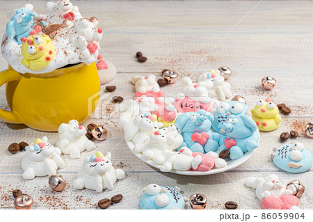 Marshmallow in the form of handmade animals on a light background. In a cup of coffee. Women's Day, Valentine's Day. Marshmallow in the form of handmade animals on a light background. In a cup of coffee. Women's Day, Valentine's Day. 86059904