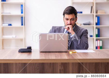 Young handsome businessman employee working in the office Young handsome businessman employee working in the office 86060664