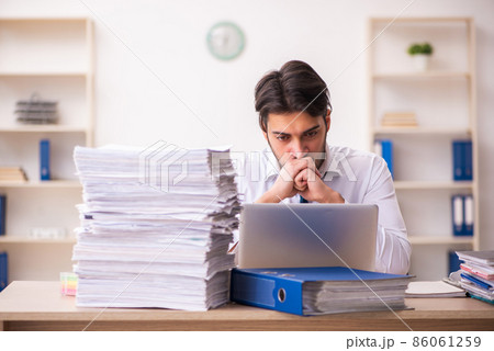 Young businessman employee unhappy with excessive work in the office 86061259